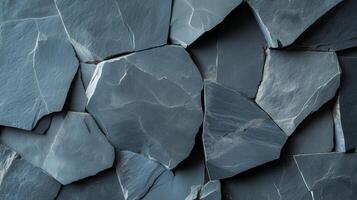 Textured gray slate stones arranged closely together in a natural pattern photo