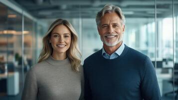 Two colleagues pose for a friendly portrait in a contemporary office setting, showcasing teamwork photo