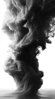 A swirling formation of black smoke rises, creating an abstract and artistic effect against white photo