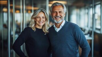 Two professionals stand together smiling in a well lit office space, exuding confidence and teamwork photo