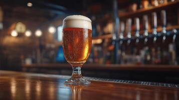 A cold glass of beer sits on the bar, showcasing its frothy top and amber color under soft lighting photo