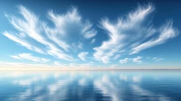 Stunning cloud formations create reflections on the tranquil ocean surface during bright daylight photo