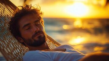 A man peacefully relaxes in a hammock as the sun sets over the ocean, creating a serene atmosphere photo
