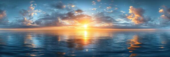 Sunrise casts golden light over tranquil sea, illuminating colorful clouds and creating a serene atmosphere photo