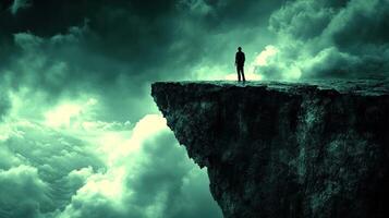 Individual gazes at expansive clouds from a high cliff surrounded by an otherworldly atmosphere photo