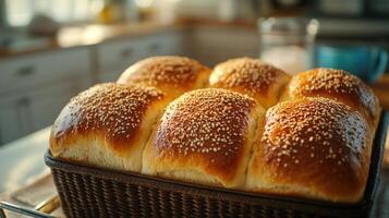 Soft sesame rolls rest in a basket, cooling in a cozy kitchen filled with warm sunlight photo