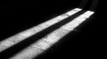 Sunlight streams through, creating stark shadows on an old stone floor photo