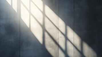 Sunlight creates a pattern of shadows on a simple concrete wall showcasing texture and depth photo