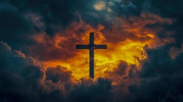 A dramatic sky illuminated by golden light highlights a silhouetted cross against dark storm clouds during sunset photo