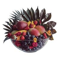 A selection of fruits artfully arranged in a bowl with leaf accents, creating a visually pleasing display. photo