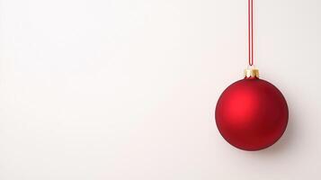 A red christmas ball hanging from a string photo