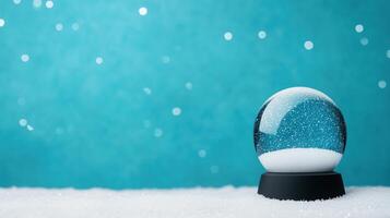 Abstract Christmas Snow Globe on Turquoise Background with Falling Snowflakes in Minimal Design for Holiday Greeting Card and Winter Decoration Highlighting Festive Seasonal Atmosphere photo