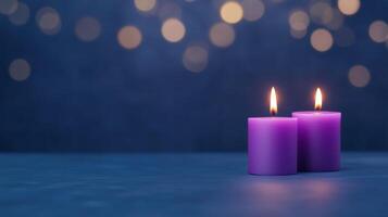 Two purple candles on a blue background with bokeh photo
