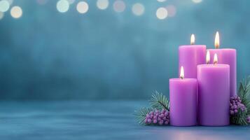 Xmas Purple Aromatic Candle Display with Blurred Lights and Evergreen Sprigs on Blue Background for Elegant Nighttime Atmosphere and Relaxation Scenes photo