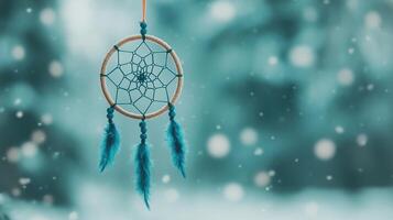 A blue dream catcher hanging from a string photo