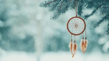 Dreamcatcher Hanging on Snow-Covered Fir Tree Branch with Winter Wonderland Scene and Mystic Wiccan Amulet for Cozy Holiday Ambiance and Nature-Inspired Tranquility in Serene Forest Setting photo