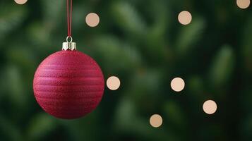Sparkling Red Christmas Ornament Against Greenery Background with Soft Bokeh Lights for Festive Holiday Designs and Seasonal Decorations in December Celebrations photo