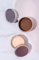 Mocha Mousse - color of the year 2025. colorful lip balms in round tin cases , mockup design photo