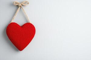 Photo frame of heart shape for mockup design on light wall background.