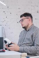 Man Working from Home on Laptop Computer in Stylish Loft Apartment photo