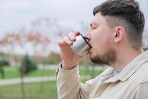 young man enjoying autumn days breathing fresh air photo