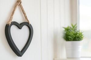 Photo frame of heart shape for mockup design on light wall background.