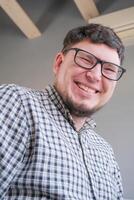 man sitting on the bed looking to the camera and smiling photo