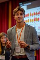 A confident young businessman giving a presentation, gesturing towards a digital screen filled with data. photo