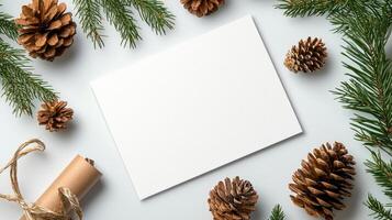 Blank greeting card surrounded by pine cones and evergreen branches, perfect for holiday messages photo