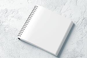 blank spiral notebook on textured surface, perfect for notes and sketches photo