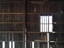 A barn with wooden slats and a window photo