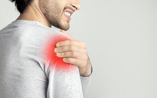 Inflammation in shoulder concept. Sore spot is highlighted in red photo