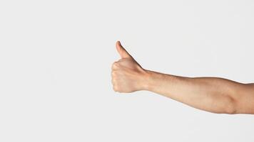 Unrecognizable millennial guy showing thumb up gesture over light background, closeup. Panorama photo