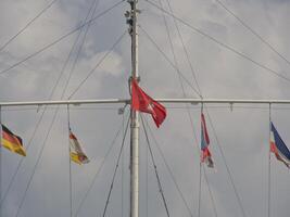 A group of flags on a pole photo