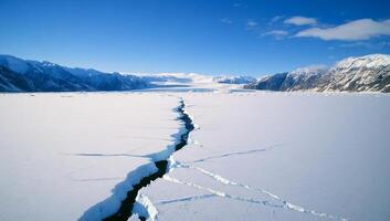 A crack in the ice in the middle of a large body of water photo