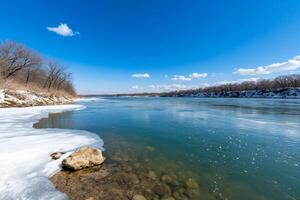 A river with ice on it and trees in the background photo