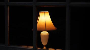One warm lamp lights on at night photo