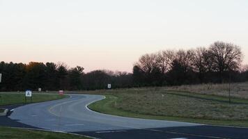 The forest view with the narrow country road across them in winter photo