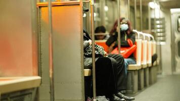 The subway interior view with several peaple sitting on the seats photo