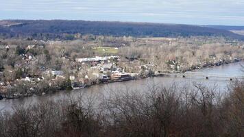 One old iron bridge cross the Delaware river between two old town in autumn photo