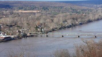 One old iron bridge cross the Delaware river between two old town in autumn photo