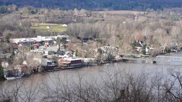 One old iron bridge cross the Delaware river between two old town in autumn photo