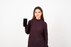 Smiling presenting and holding blank screen smartphone Of Beautiful Asian Woman Isolated On White Background photo