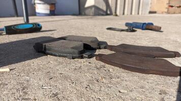 A CloseUp View of Vehicle Brake Pads Laid Out on the Workshop Floor Surface Area photo