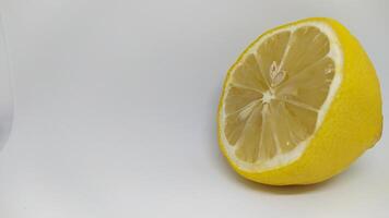 A Fresh Lemon Half Displayed on a Vibrant White Background, Ideal for Culinary Use photo