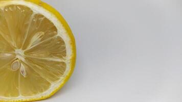 A Fresh Lemon Slice is beautifully displayed on a pristine White Background for presentation photo
