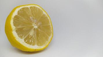 A Fresh Lemon Half that Showcases its Vibrant Yellow Color and Offers a Juicy Texture photo