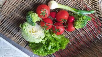 A Beautiful Array of Fresh Organic Vegetables Artfully Displayed on a Rustic Basket photo
