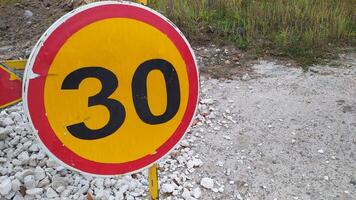 A Speed Limit Sign prominently displayed at the roadside to inform drivers and cyclists photo