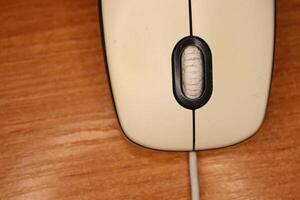 An UpClose View of a Vintage Computer Mouse Resting on a Wooden Surface for Aesthetic Appeal photo